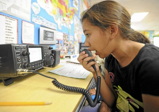 young BIPOC girl communicating via ham radio